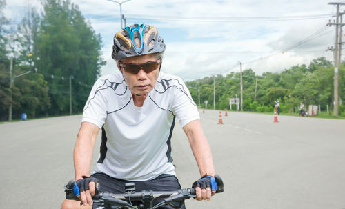 Man riding bicycle on road