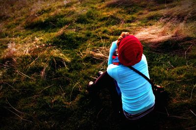 Girl sitting on grass watching the sunset