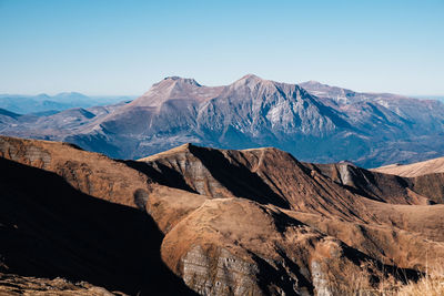 Scenic view of snowcapped mountains against clear sky in amatrice, lazio italy 