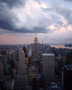 View of cityscape against cloudy sky