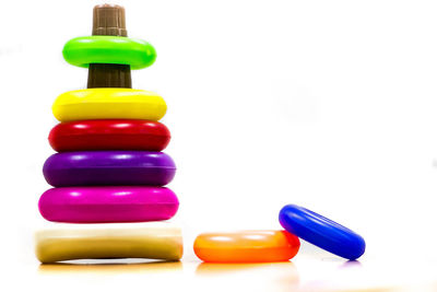 Close-up of multi colored bottles against white background