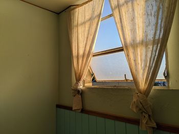 Low angle view of house seen through window