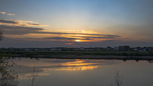 Scenic view of river against sky during sunset