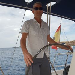 Portrait of man standing on boat in sea