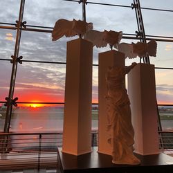 Low angle view of railing against sky during sunset