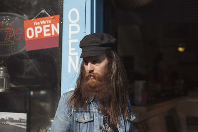 Man with beard exiting a store