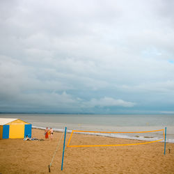 People of beach against sky