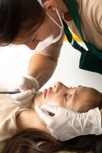 High angle view of doctor examining patient in hospital