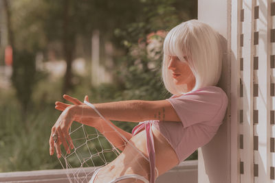 Side view of girl sitting outdoors