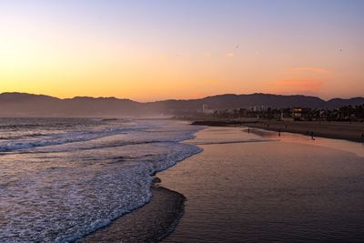 Scenic view of beach against sky during sunset