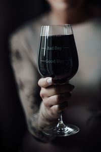 Close-up of woman hand holding glass of wine