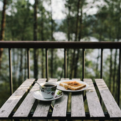 Breakfast on table against balcony