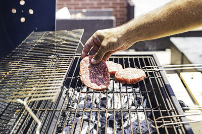 Burger barbecue roasted on metal grill. the person cooking burger