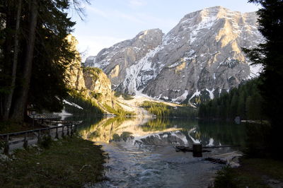 Scenic view of lake by mountains against sky