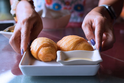 Hands holding plate with food