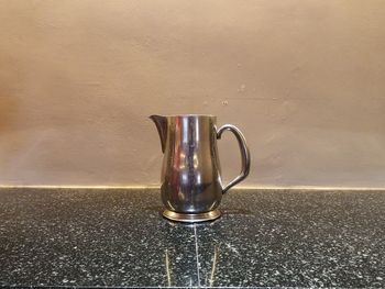 Close-up of drink on table against wall