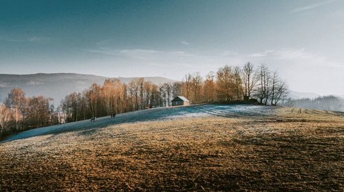 Snow covered landscape against sky