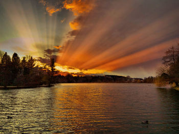 Scenic view of lake against orange sky