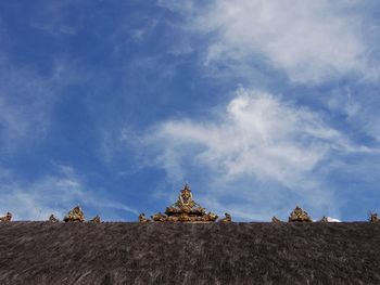 Low angle view of temple against cloudy sky