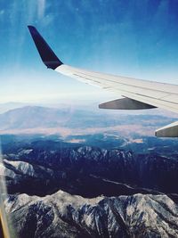 Cropped image of airplane flying over landscape