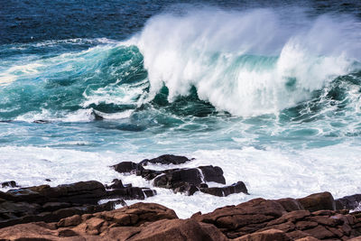 Waves splashing on rocks at shore