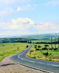 Road passing through landscape against sky