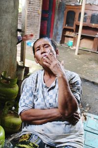 Portrait of old woman against smoking