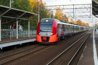 Modern intercity high speed train at sunset. commercial suburban railroad transportation concept.