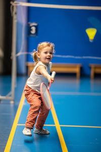 Portrait of boy playing with balls on court