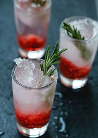 High angle view of drinks in glass on wet table