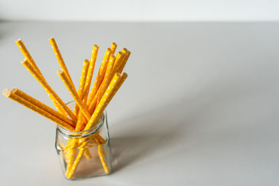 Close-up of lemon slice on table against white background