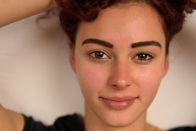 Close-up portrait of smiling young woman