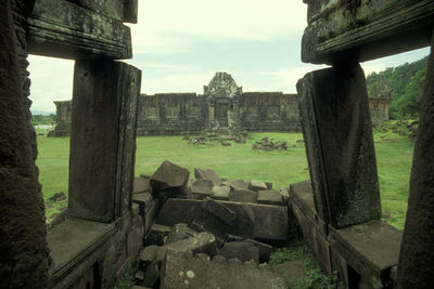 Old ruin on field against sky