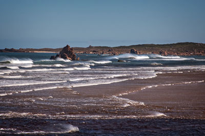 Scenic view of beach against clear sky