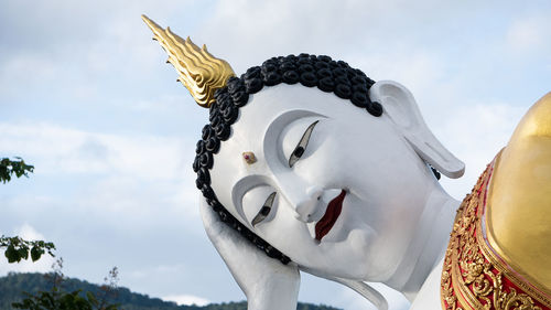 Low angle view of statue against building against sky