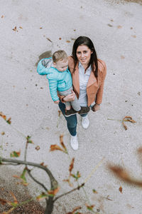 High angle portrait of mother and son on floor