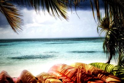 Low section of woman relaxing on beach