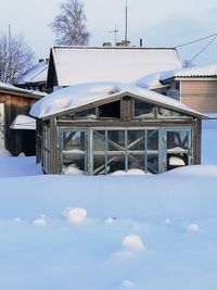 Snow covered house against sky