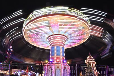 Low angle view of illuminated ferris wheel at night