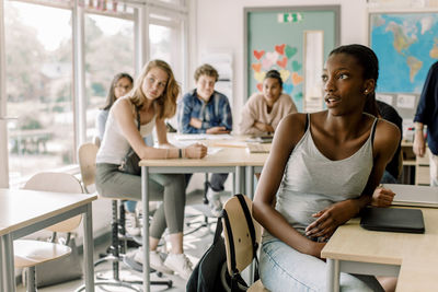 Teenage students sitting in classroom