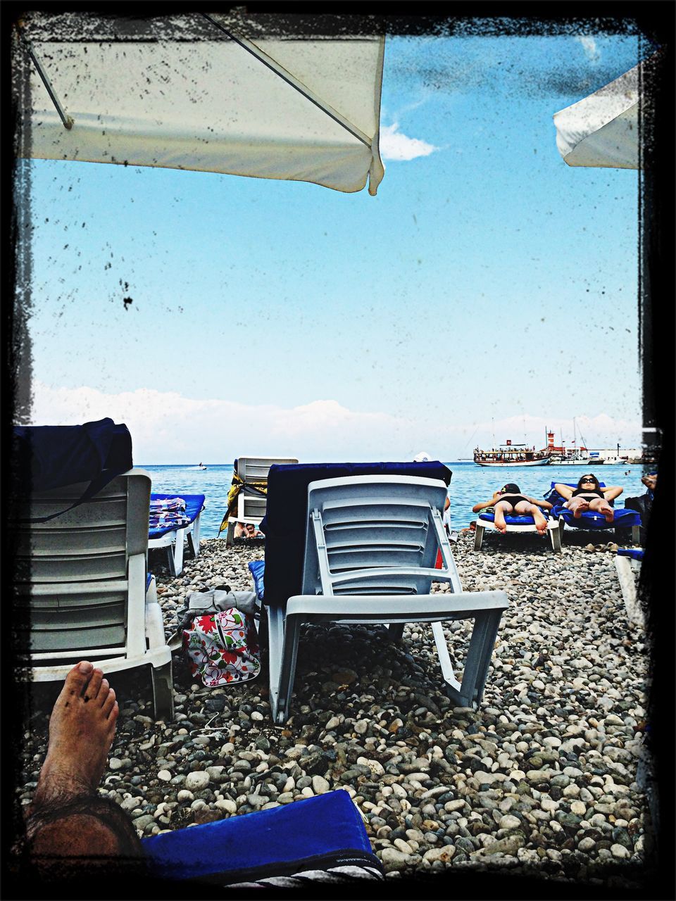 sea, beach, transfer print, lifestyles, leisure activity, men, auto post production filter, relaxation, person, sitting, water, sky, horizon over water, chair, vacations, beach umbrella, clear sky, shore