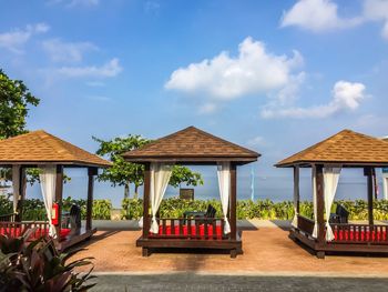 Gazebo on table by building against sky