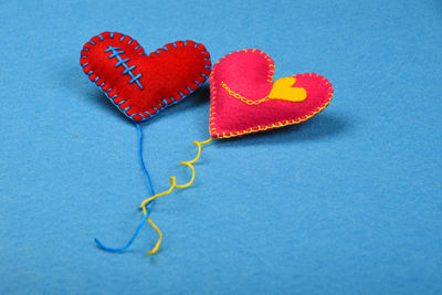 High angle view of heart shape decorations on blue fabric