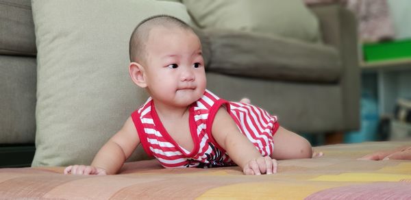 Portrait of cute baby sitting on table