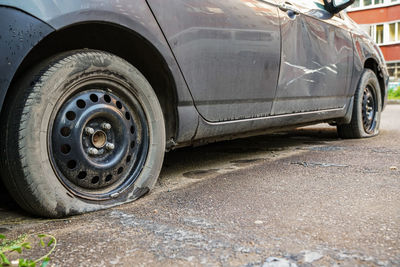 Close-up of old vintage car on road