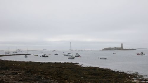 Sailboats on sea against sky