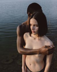 Woman looking at camera while standing in water