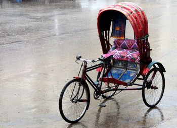 Old pedicab on wet road