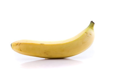 Close-up of yellow fruit against white background