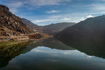 Scenic view of lake and mountains against sky